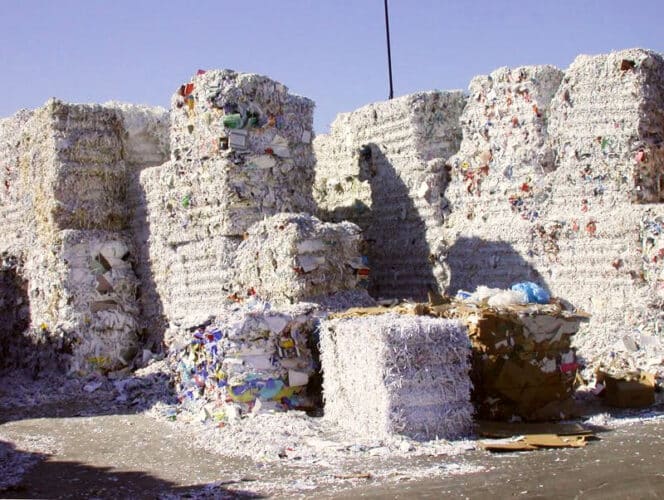Bales of recycled cardboard and paper - recycling services icon